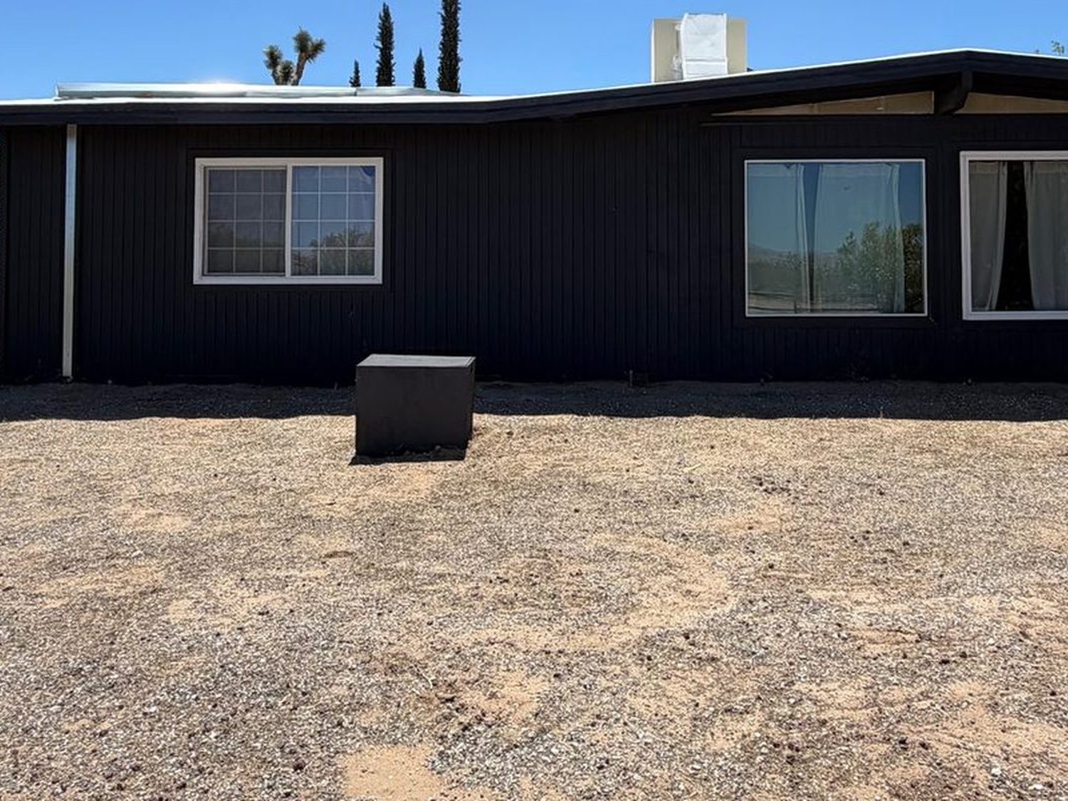 Front yard before, bare dirt running along the side of the house