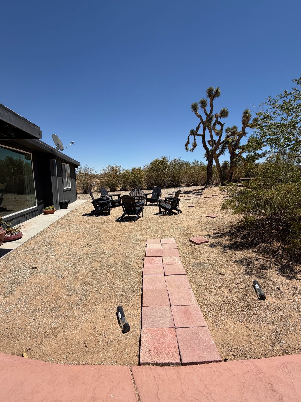 Seating area before, folding chairs on bare decomposed granite