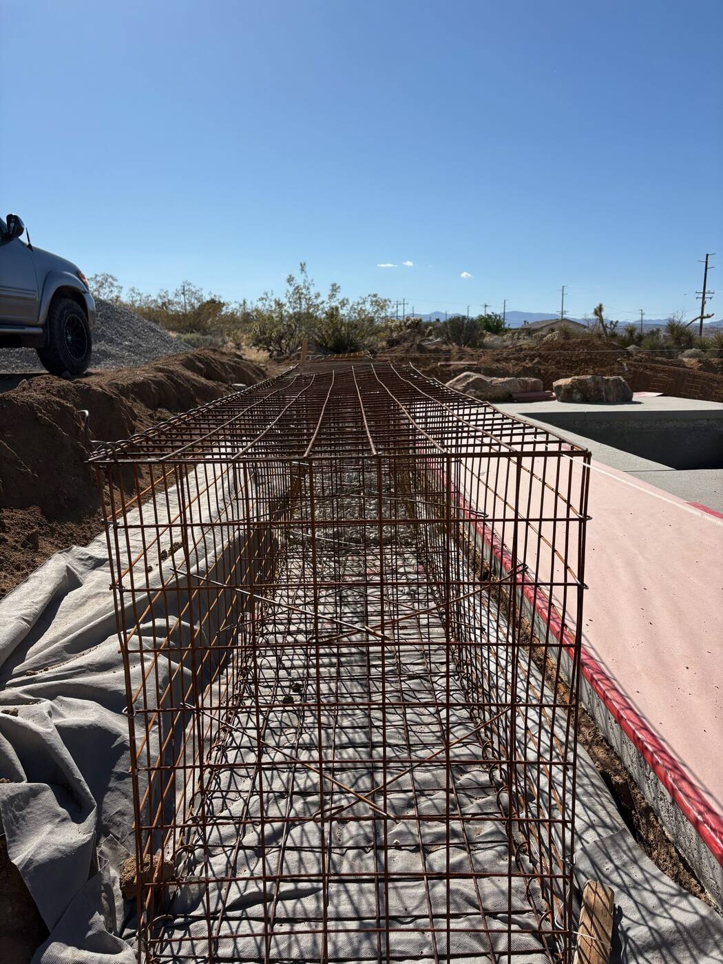 Looking down the length of an empty, tied gabion cage before stone fill