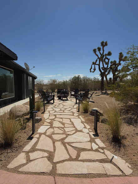 Flagstone path leading to a fire pit lounge with desert views
