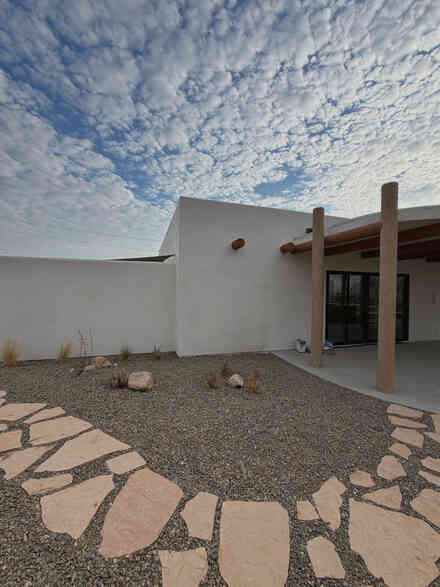 Stone patio and stucco walls of a modern desert home